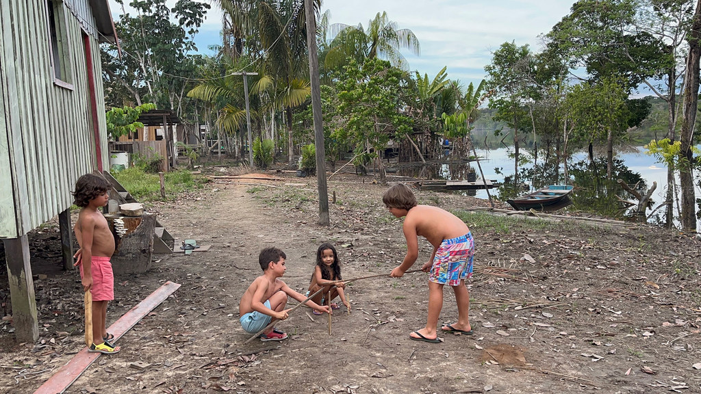 Children play on the banks of the River Negro, a tributary of the Amazon River in northwestern Brazil.
